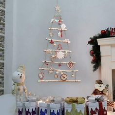 a small christmas tree sitting on top of a table next to presents and other decorations