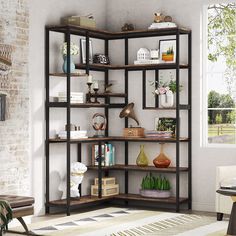 a living room with an open shelving unit filled with books, vases and other decorative items