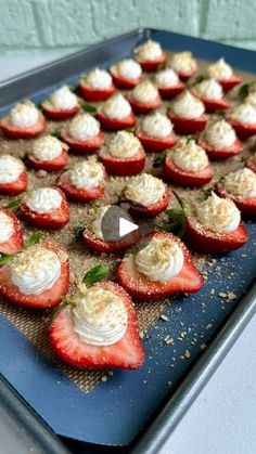 strawberries with whipped cream and mint leaves on a baking sheet ready to go into the oven