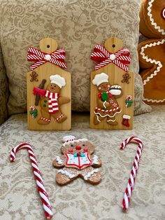 gingerbread man and woman cut out from wood with candy canes