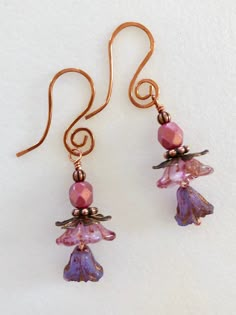 "Darling new Czech glass Premium flower earrings in pink and lilac opaline with pink luster beads and copper accents. Translucent pink opaline bellflowers with copper Picasso finish are accented with little Czech glass lilies in lilac opaline with metallic copper wash. Wire wrapped in bright copper with copper accents. Ear wires are handmade German copper with cute spiral design. Total drop is 2\"." Picasso Flowers, Beaded Jewelry Inspiration, Glass Flower Earrings, Bright Copper, Aquamarine Earrings, Boho Handmade, Copper Accents, Metallic Copper, Pink Lilac