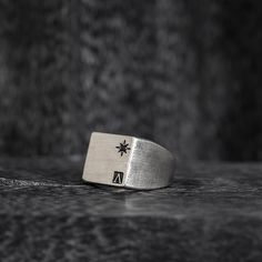 Introducing the Oval Signet Ring - a reworked design that exudes elegance and sophistication. This ring features the iconic message ____ engraved around the crown, serving as a reminder of the wearer's triumphs and accomplishments. Crafted in the classic signet ring style, this piece is a timeless addition to any jewelry collection. The oval shape adds a modern touch, while the intricate details showcase the expert craftsmanship. With its meaningful message and beautiful design, this ring is perfect for those who want to make a statement and leave a lasting impression. "All conditioned things are Impermanent."-Sterling silver 925.-Size: 20mm by 15mm. Thickness 1-2mm.-Engraved around the crown. Specifications -Signet Ring style, reworked design. -Sterling silver 925. -Size: 20mm by 15mm. Th Classic Silver Engraved Logo Ring, Elegant Formal Ring With Engraved Logo, Elegant Formal Rings With Engraved Logo, Elegant Engraved Logo Ring For Formal Occasions, Classic Formal Rings With Engraved Logo, Luxury Silver Jewelry With Engraved Logo, Luxury Silver Rings With Etched Details, Elegant Silver Jewelry With Engraved Logo, Luxury Etched Ring Jewelry