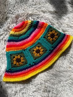 Meet this adorable rainbow sunflower sun hat made with all acrylic scrap yarns. Perfectly lightweight for summer with a floppy brim to shield your eyes from the sun's rays. Brighten up any outfit with this eclectic piece🌈💕 One size fits most (average-22.5 inch head circumference) MEASUREMENTS  *Circumference: 22 inches around when lying flat/unstretched *Diameter across top (rainbow part): 9.5 inches *Sunflower square dimensions: 4 inch wide x 3.5 inches long *Brim width: 2 inches *All scrap acrylic yarn Hand wash with cool/warm water and air dry for best results. Do not bleach or iron. Feel free to message me any questions or concerns you may have🤗 Much love Multicolor Hippie Cap, Playful Multicolor Brimmed Sun Hat, Fun Multicolor Spring Hat, Hippie Multicolor Spring Hat, Multicolor Hippie Hat For The Beach, Funky Multicolor Summer Hat, Colorful Bohemian Crochet Hat, Yellow Bohemian Crochet Hat For Spring, Colorful Crochet Hat One Size