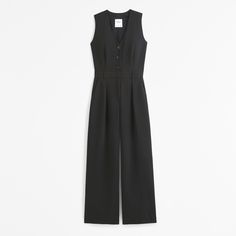 Our versatile vest jumpsuit in our soft crepe fabric, featuring a button-through detail, v-neckline, back zipper closure and a belted waist. Elegant V-neck Jumpsuits And Rompers For Daywear, Fitted V-neck Jumpsuits And Rompers With Buttons, Elegant V-neck Jumpsuit Or Romper With Buttons, Fitted V-neck Jumpsuit With Button Closure, Medium Wash Button-up Jumpsuits With Pockets, Black V-neck Jumpsuit With Pockets, Crepe Fabric, Athletic Fits, New Arrival Dress