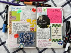 an open notebook with lots of stickers and writing on the pages next to markers