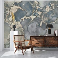 a marbled wall with a wooden chair and sideboard in the foreground, next to a lamp on an end table