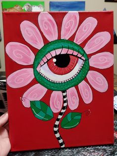 a painting of a flower with an eye on it