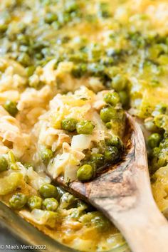 a casserole dish with peas, rice and chicken is shown in a pan