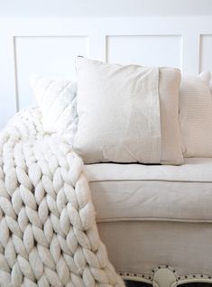 a white couch with some pillows on top of it