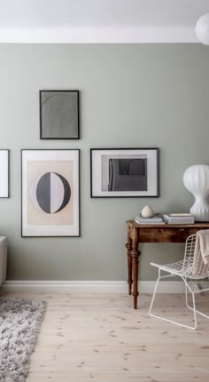 a living room filled with furniture and pictures on the wall