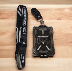 a lanyard with an id badge attached to it on a wooden table next to a pair of scissors