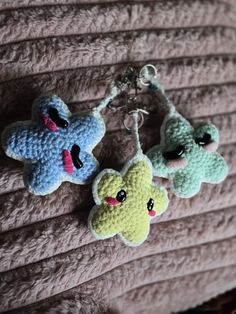 three crocheted keychains hanging on a wall