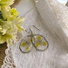 Yellow Forget-Me-Nots and Queen Anne's Lace Dried Flower Earrings Add a touch of nature's beauty to your jewelry collection with these stunning handmade earrings featuring real pressed yellow forget-me-nots and Queen Anne's Lace. Encased in high-quality resin, these delicate flowers are preserved in all their spring and summer glory, creating a timeless piece that captures the essence of the seasons. Perfect for bridesmaid jewelry, these resin flower earrings offer a unique and personal touch to Yellow Hypoallergenic Flower-shaped Earrings, Silver Earrings With Pressed Flowers For Wedding, Silver Wedding Earrings With Pressed Flowers, Wedding Silver Earrings With Pressed Flowers, Gold Pressed Flower Earrings For Mother's Day, Yellow Flower-shaped Earrings For Gifting, Yellow Flower Earrings As Gift, Yellow Flower Earrings For Gift, Yellow Flower Shaped Earrings For Gift