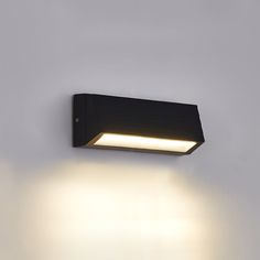 a black light fixture mounted on the side of a wall