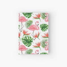 a pink flamingo and tropical leaves pattern on a white background hardcover notebook with the cover closed