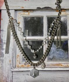 This is a fun eclectic double strand necklace. The Eiffel Tower Charm and the Crown are sterling silver. The perfect gift for that someone special. I T E M ∙ S P E C I F I C A T I O N S: - CHAIN LENGTH: Necklace is made with silver chain and crystal rosary bead chain. Silver chain is not sterling. Double Strand- Short strand is 20" in length, Longest Strand is 24" - you can link the clasp in another loop and make it shorter if you prefer. - PENDANT SIZE: Sterling Silver Crown is 1/2" long, Paris Silver Double Strand Necklace For Layering, Silver Dangle Charm Necklace, Silver Double Strand Necklace, Silver Double Chain Jewelry As Gift, Silver Charm Necklaces With Chain For Layering, Silver Charm Necklaces For Layering, Silver Layered Pendant Necklace For Party, Silver Pendant Jewelry With Double Chain, Silver Charm Necklace For Layering