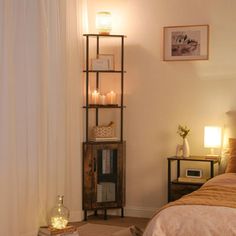 a bed room with a neatly made bed and a night stand next to the window