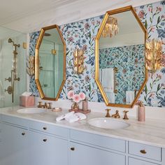 two sinks and mirrors in a bathroom with floral wallpaper