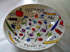 a bowl that has some writing on it and pictures in the bottom, along with other words