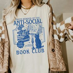 Get ready to be OBSESSED with your new book club shirt. It's the cutest and most trendy way to combine all those important trendy light academia and retrovibes! This is the perfect book lover shirt!  * Q U I C K * F A C T S * ✺  All shirts are UNISEX ✺  100%  ringspun cotton (fiber content may vary for different colors) ✺  Soft-washed, garment-dyed fabric brings extra coziness ✺  Wash and dry normally (on cool for best results) ✺  Sewn-in twill label * S I Z I N G * ✺ For an oversized fit, select two or three sizes up from your normal size ✺ Model is wearing size L  ✺ Sizing runs true to size ✺ Relaxed fit ✺ Most women find their typical size works best, since they are meant to fit a touch loose ✺ See Size guide and fit in images          * S H I P P I N G * T I M E S * ✺ Our items are ind Book Graphic Tees, Book Lover Shirt, Book T Shirts, Book Worm Gifts, Book Club Shirt, Books Shirt, Bookish Merch, Book Shirt, Book Clothes