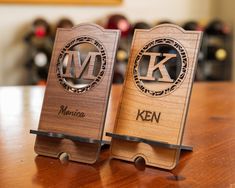 two wooden business card holders with the letter k and m on them sitting on a table