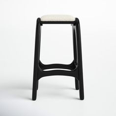 a black stool with a white cushion on it's seat and backrests