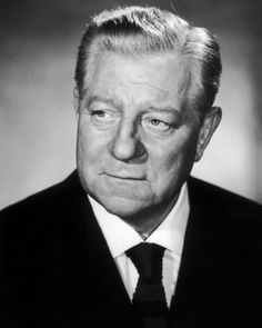 an old black and white photo of a man in a suit with a serious look on his face