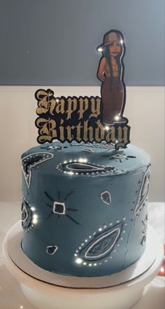 a blue birthday cake with an image of a woman on top and the words happy birthday