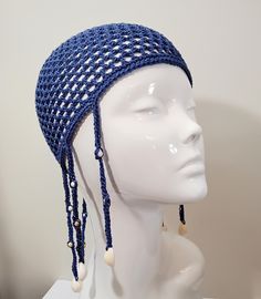 This petrol blue mesh skull cap has a cool beach feel to dress up your holiday and festival outfits. Hand crafted with high quality, fine mid blue cotton yarn, the hat is finished with seven long braids along the side and back. Each braid is decorated with white and natural coloured wooden beads and a cowrie shell on the end. If you would prefer this skull cap in a different size or colour, please message me and I will be happy to help. Measurements: Head circumference 56cm Crown to base 18cm Each braid is 15cm in length and features two wooden beads and a small cowrie shell on the end. Care Instructions: Handwash or machine wash on a wool cycle at 30oC and dry flat. Do not iron. Posting: Orders are sent on a Royal Mail Tracked 48 or International Tracked service. If you are in the UK, you Blue Adjustable Headband Costume Hat, Adjustable Blue Headband Costume Hat, Adjustable Blue Costume Headband, Fitted Crochet Beanie For Beach, Summer Rave Festival Hats, Bohemian Adjustable Costume Hats And Headpieces For Beach, Bohemian Adjustable Costume Hats For Beach, Adjustable Bohemian Beach Costume Hats And Headpieces, Blue Summer Headband Costume