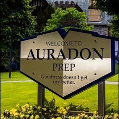 the welcome sign to auradon prep is in front of some flowers and trees