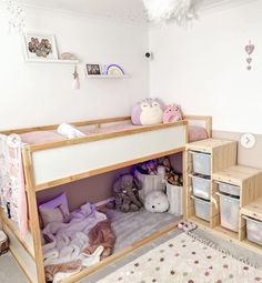 a child's bedroom with bunk beds and storage bins on the bottom floor