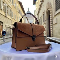 This bag has been made of the best genuine leather by local master crafters of Florence in Italy, designed for women who only accept premium Italian quality and luxury leather bags and modern Italian fashion. . Sizes: Width: 29cm/10.6 inch Height: 19cm/7.4 inch Depth: 7 cm/3.9 inch The story of this bag:  John was visiting Florence with his family and he wanted to find the perfect gift for his wife and daughters. He had heard about the exquisite leather craftsmanship in the city and was determin Luxury Brown Bags For Daily Use, Luxury Brown Satchel Bag, Chic Brown Leather Satchel, Luxury Camel Top Handle Satchel, Luxury Brown Satchel For Daily Use, Luxury Brown Rectangular Flap Bag, Elegant Satchel Flap Bag With Leather Handles, Brown Leather Top Handle Satchel, Dark Tan Leather-lined Satchel Shoulder Bag