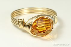 Gold Topaz Crystal Ring Handmade by Jessica Luu Jewelry  ~ Modern ~ Sparkling ~ Glamorous ~ A faceted, round crystal is wrapped by hand with 14K gold filled wire in a solitaire ring that is hand crafted just for you. Topaz is November's birthstone making this a thoughtful birthday gift for someone special. MATCHING ITEMS https://www.etsy.com/shop/JessicaLuuJewelry?search_query=orange+topaz DETAILS: ~ 8mm topaz crystal from Austria ~ 14K yellow or rose gold filled wire HOW IT'S MADE: Each ring is Right Hand Ring, Topaz Crystal, Gold Topaz, Orange Crystals, Right Hand Rings, Hand Ring, November Birthstone, Crystal Ring, Wrapped Jewelry