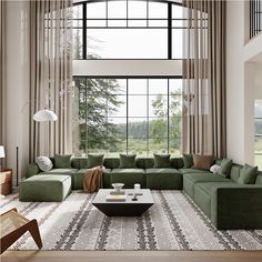 a living room with large windows and green couches