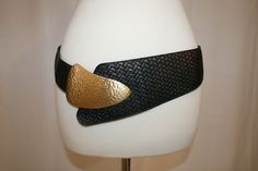 "1980s Belt with Leather in Front with wide black elastic in back Leather has a printed herringbone pattern in a subtle bronze metallic finish. Leather is 2\" wide with 3.5\" at widest point.  Leather connects to 2\" wide elastic on back. Buckle is hammered brass or gold colored metal. Belt loops through buckle. Buckle has a hook which attaches to a grommet on belt.  Measures: 34\" without any stretch - could be adjusted as belt does loop through Great to wear over a sweater on natural waist or hip area.  Condition Very Good Vintage Condition - the belt loop on back of buckle is in two pieces (review photos) not sure if this is broken or supposed to be like this. Has no effect on use of belt." Brass Belt, Brass Belt Buckles, Hammered Brass, Fashion Capsule, Metal Belt, Suspender Belt, Herringbone Pattern, 1980s Vintage, Belt Buckle