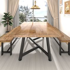 a wooden table sitting in front of a window next to a potted green plant