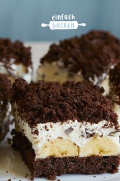 three pieces of cake on a plate with white frosting and chocolate shavings