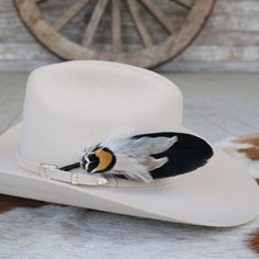 This handmade arrangement of feathers is the perfect way to set your hat apart from the rest. Simply tuck into the band of any hat.  Made with a mix of pheasant, goose, and rooster feathers. Approximately 7 inches long, sizes may vary due to being made with natural materials. Includes: 1 Handmade Arrangement of Feathers. How to use: Tuck into the hat band of any hat. *Each one will vary slightly due to being handmade. *Hat not included. Custom Feather Hat Bands For Country Events, Southwestern Feather Hat Band For Country Events, Western Hat Bands With Feathers For Rodeo, Western Style Brimmed Top Hat With Feathers, Western Hat Band With Feathers For Kentucky Derby, Country Style Hat Bands With Feathers For Western-themed Events, Southwestern Hat Bands With Feathers For Ranch, Country Style Feathered Hat Bands For Western-themed Events, Vintage Feather Hat Bands For Western-themed Events