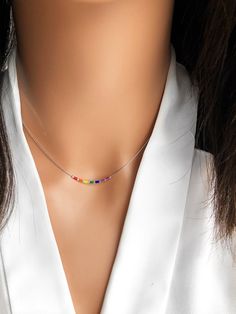 This delicate rainbow necklace is made with tiny colorful beads strung on a thin silver plated necklace. A simple minimalist necklace that can be worn alone or layered. - Silver plated - Tiny beads - Jewelry is packaged in box and ready to gift - Ships in 1-2 days! Available in sterling silver in our sister store https://www.etsy.com/listing/1072152865/sterling-silver-rainbow-necklace-silver?ref=shop_home_recs_15 Also available in plated gold: https://www.etsy.com/listing/943577809/rainbow-neckl Pride Necklace, Necklace Colorful, Rainbow Necklace, Rainbow Beads, Hand Stamped Jewelry, Silver Plated Necklace, Silver Plated Jewelry, Bead Stringing, Colourful Necklace