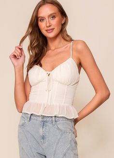 Effortlessly elevate your wardrobe with our Ivory Smocked Back Corset Top. Dress it up for a special occasion or dress it down for a casual day out. Style it alone for a chic look or layer it with a blazer for a touch of sophistication. Delicate frilly hem and cami straps add a feminine touch to this versatile piece. Available in Small, Medium and Large Runs true with smocked back for a flattering stretchy fit Corset Top Dress, Chic Look, Days Out, Top Dress, Corset Top, Concert Outfit, Smocking, Shirts Tops, Special Occasion