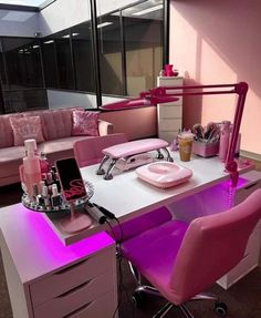 an office with pink furniture and accessories on the desk