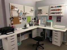 a desk with several drawers and a printer on it in an office space that is well organized