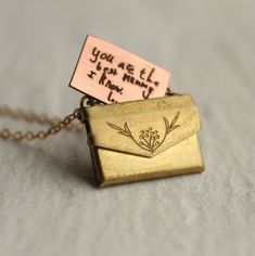 This charming personalised locket is shaped like a tiny envelope with a working clasp, and fitted inside is a tiny surprise message! Your message will be beautifully engraved on a solid copper letter in our Edinburgh studio, and can be personalised either in your own handwriting or a beautiful vintage copperplate script. Both options are shown in our photos. HOW TO SUBMIT HANDWRITING FOR LOCKET Once you have purchased the locket, please go ahead and message us with an photo of your handwritten m Copper Letters, Tiny Envelopes, Engraved Locket, Handwriting Necklace, Cute Couple Gifts, Bridesmaid Necklace, Locket Necklace, Name Necklace, Couple Gifts