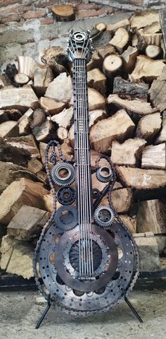 a metal instrument sitting on top of a pile of wood