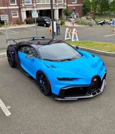 a blue bugatti is parked in the parking lot