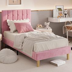 a bedroom with pink and white furniture in it