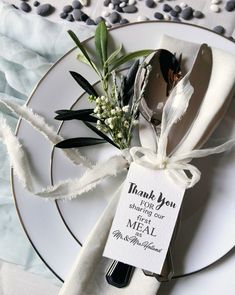 a white plate topped with a fork and knife next to a napkin on top of a table