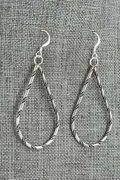 These sterling silver earrings were made by Navajo silversmith Nashina Leonard.Length: 2 1/4"Width: 1"Free shipping on all orders! We ship with USPS and always include tracking. All orders ship within a day of payment.Returns are accepted up to 30 days after you receive your order. Just send us a message. Our shop offers cash back or store credit. The item must be returned in new condition. Silver Southwestern Drop Earrings, Silver Southwestern Style Teardrop Dangle Earrings, Southwestern Silver Dangle Teardrop Earrings, Southwestern Silver Drop Earrings, Southwestern Style Silver Drop Earrings, Southwestern Silver Teardrop Earrings, Artisan Sterling Silver Nickel-free Teardrop Earrings, Traditional Nickel-free Sterling Silver Teardrop Earrings, Silver Southwestern Hoop Earrings As Gift