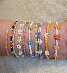 This listing is a collection of 10, spring-themed, dainty minimalistic beaded bracelets! Perfect for Easter and the whole spring season. Boho stackable bracelets strung on strong beading string, very durable making them perfect for everyday wear. A wonderful gift for someone or yourself! Each bracelet is sold separately and numbered in pictures 2 and 3 so you can make sure you're getting the right bracelet. They come in many sizes, and let me know if you don't see yours! All of our jewelry comes gift-wrapped in a little bag, making them the perfect gifts for best friends, gifts for her or to treat yourself! Or would be cute friendship bracelets! They ship very quickly! Spice up your jewelry collection with these beaded bracelets. If you have any questions or anything else feel free to cont Bohemian Jewelry With Letter Beads For Spring, Spring Bohemian Jewelry With Letter Beads, Bohemian Round Beads Bracelets For Spring, Bohemian Spring Bracelets With Round Beads, Delicate Adjustable Summer Bracelets, Delicate Adjustable Bracelets For Summer, Delicate Adjustable Bracelet For Summer, Bohemian Beaded Bracelets With Tiny Beads For Spring, Spring Bohemian Beaded Bracelets With Tiny Beads