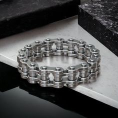 Celebrate your love for adventure with our Rugged 925 Sterling Silver Bicycle Moto Bike Chain Wedding Band. This distinctive ring captures the spirit of the open road and the thrill of biking through its intricately designed chain pattern that mimics a real bike's drive chain. Ideal for those who live life on two wheels, this wedding band is crafted with durability in mind, ensuring it withstands the rigors of daily wear while maintaining its stylish appeal. Whether you're a biker, cyclist, or s Stainless Steel Chain Link Ring For Gift, Silver Stainless Steel Biker Jewelry, Biker Style Stainless Steel Jewelry For Biker Events, Silver Stainless Steel Jewelry For Biker Events, Biker Style Sterling Silver Jewelry For Biker Events, Adjustable Silver Jewelry For Biker Events, Silver Biker Jewelry As A Gift, Biker Style Chain Jewelry For Biker Events, Silver Biker Bracelets For Gift